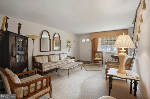 a living room with furniture a rug and a flat screen tv