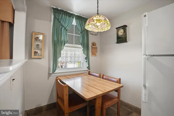 a view of a dining room with a table and chairs