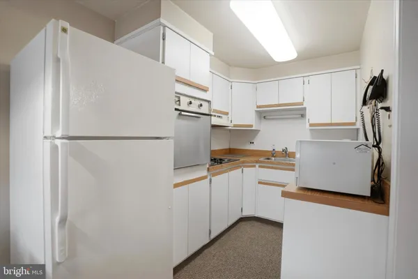 a kitchen with stainless steel appliances a refrigerator and a stove top oven