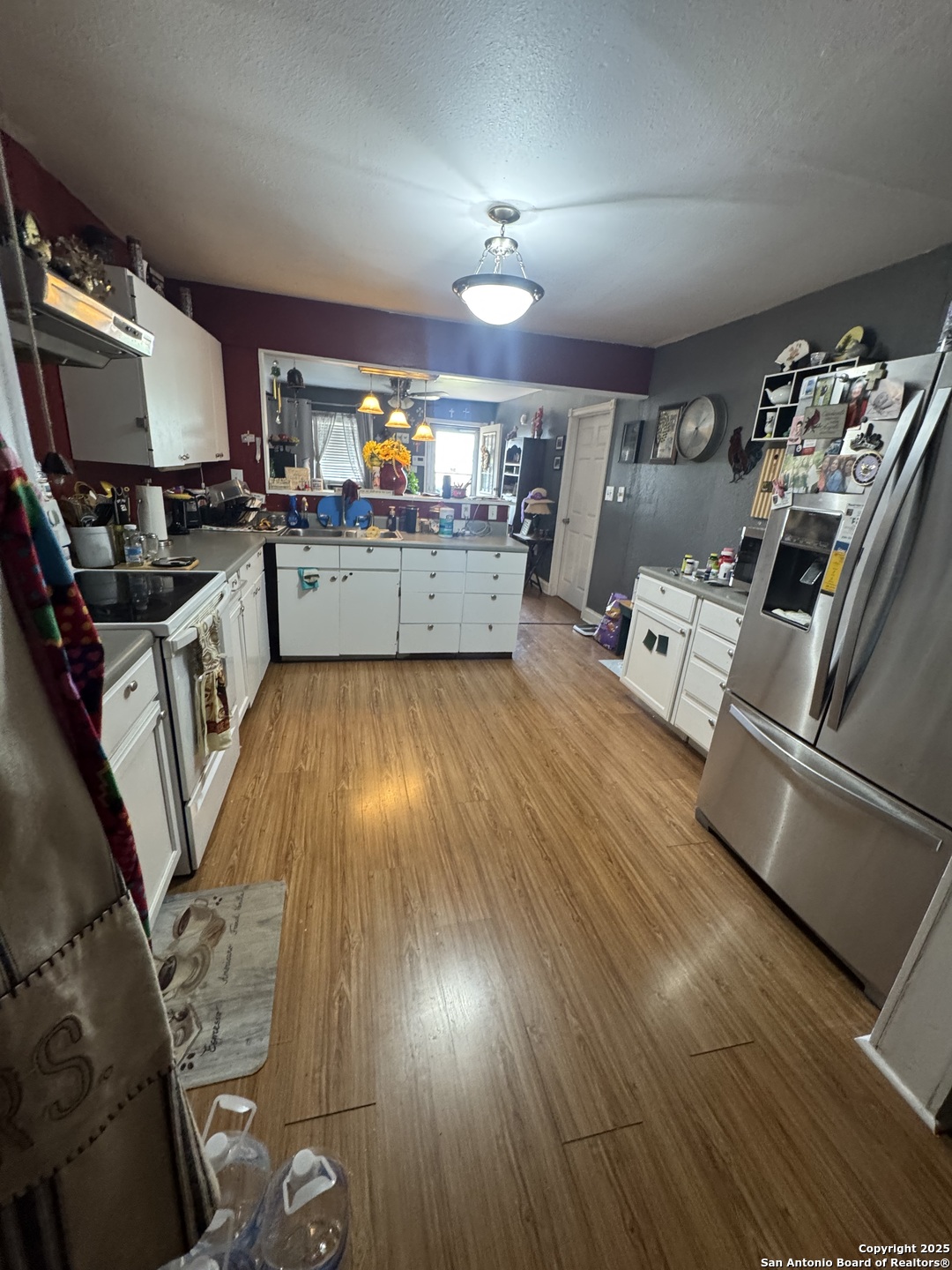 223 West Rio Grande Street Pearsall, TX 78061 - Photo 13 of 14 a kitchen with counter top space a sink and appliances