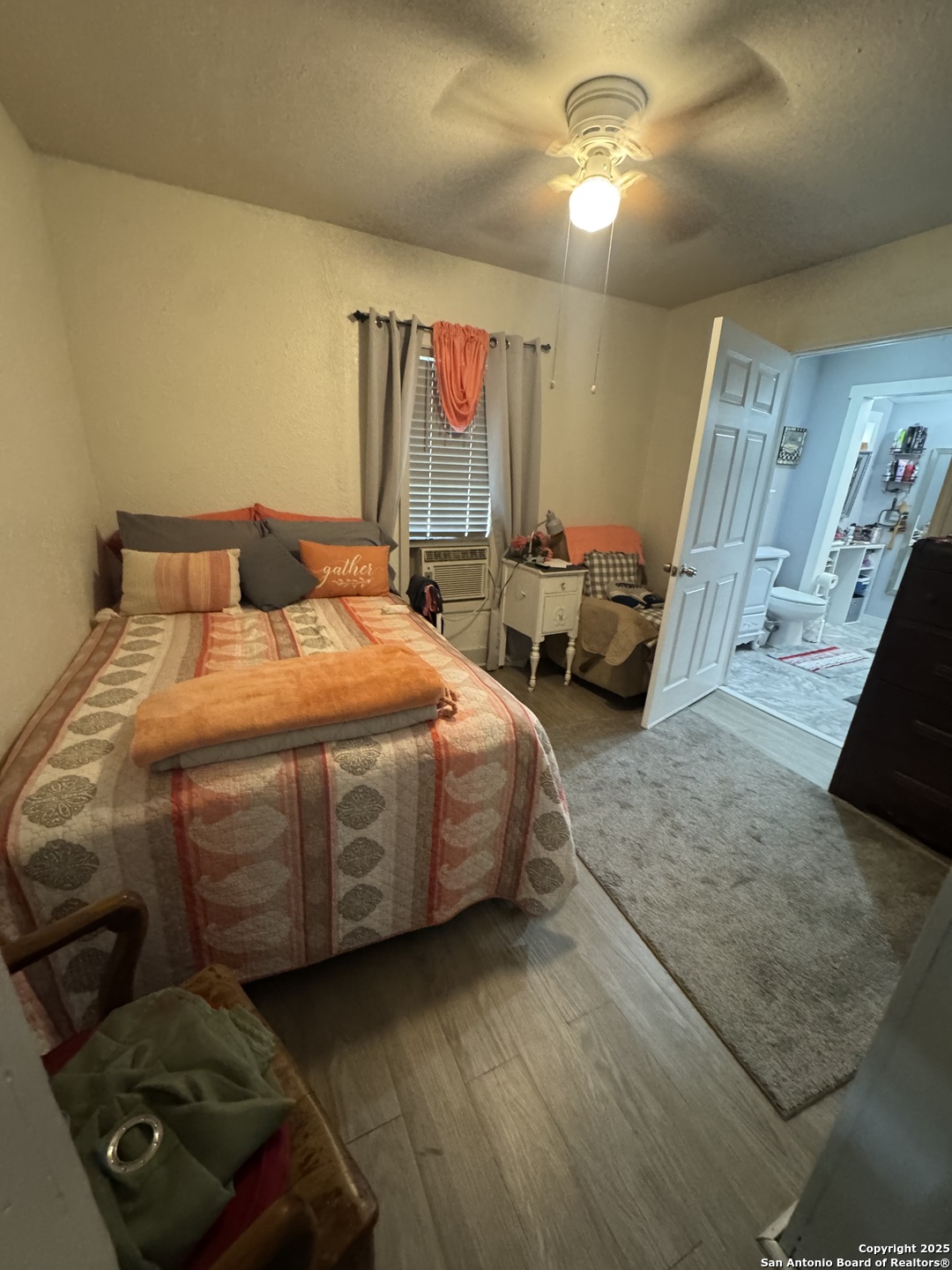 223 West Rio Grande Street Pearsall, TX 78061 - Photo 7 of 14 a bedroom with a bed mirror and window