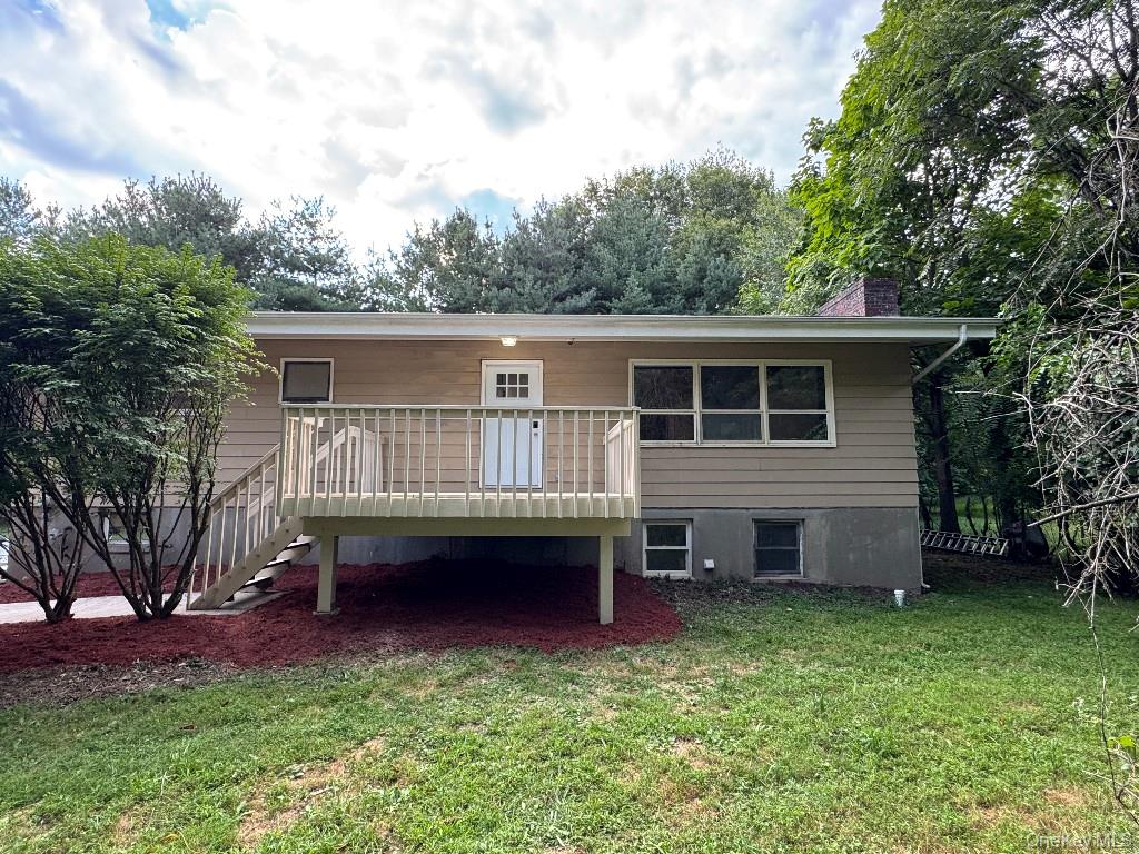 a view of a house with a backyard and a patio