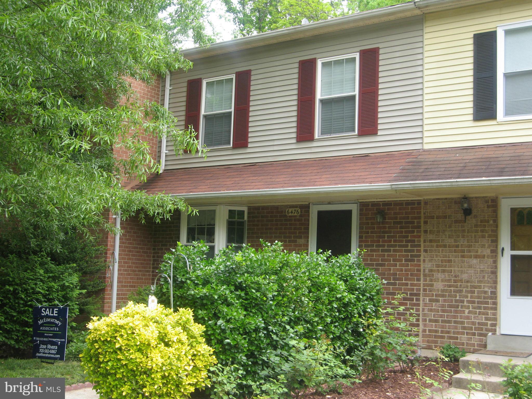 6476 O'Hara Ct Drive Springfield, VA 22152 - Photo 2 of 2 a view of a house with brick walls and a flower garden