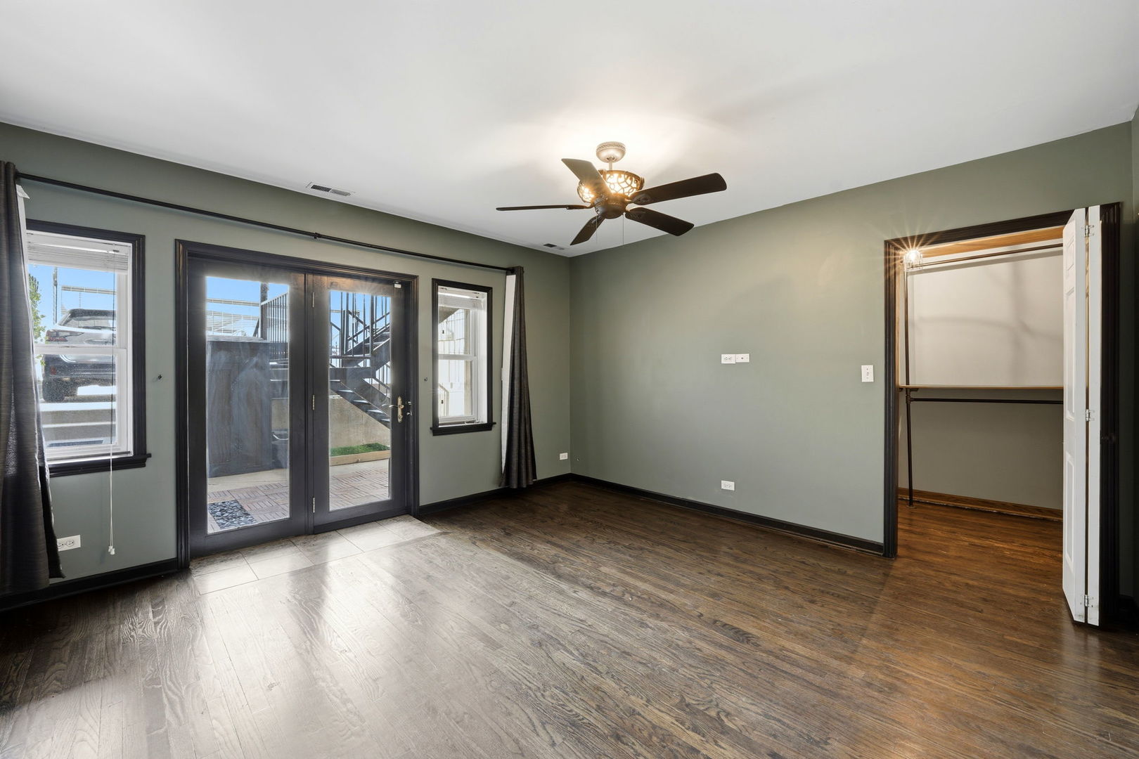 619 North Racine Avenue, Unit 1 Chicago, IL 60642 - Photo 20 of 36 a view of an empty room with a window and wooden floor