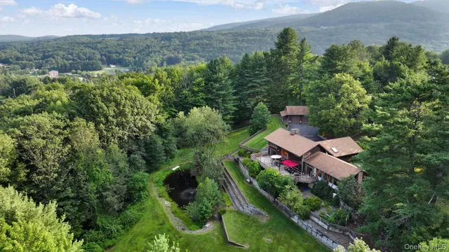 an aerial view of a house with a yard and lake view