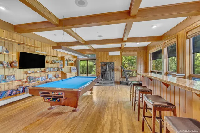 a outdoor living space with furniture and flat screen tv