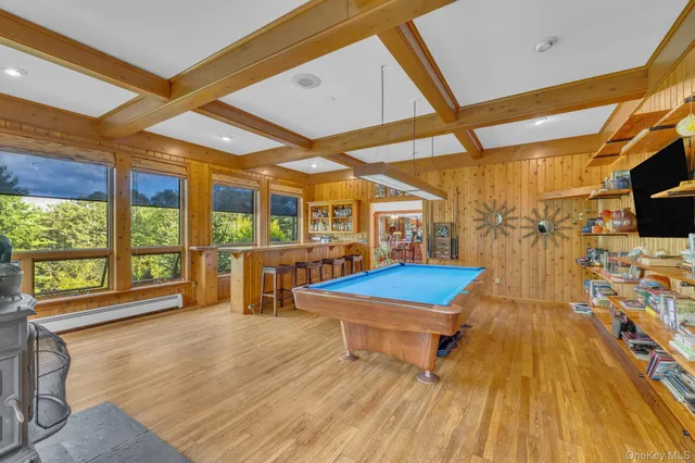 a room with pool table and a floor to ceiling window