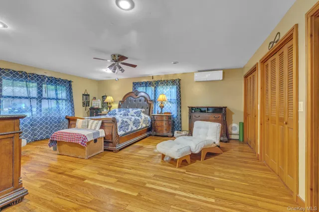 a bedroom with furniture and a wooden floor