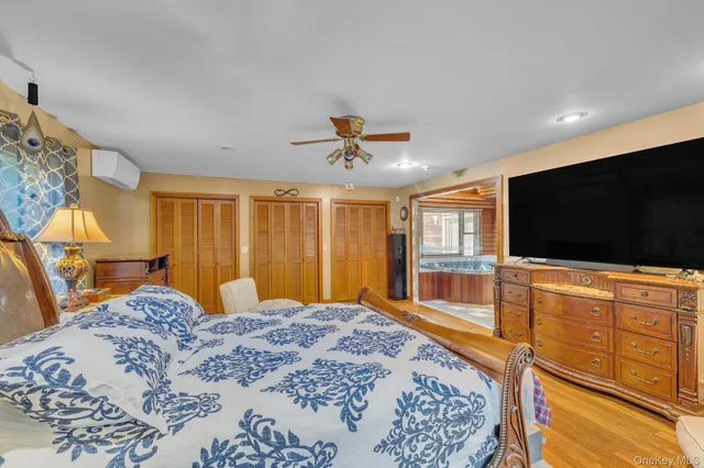 a bedroom with a bed and a flat screen tv on dresser
