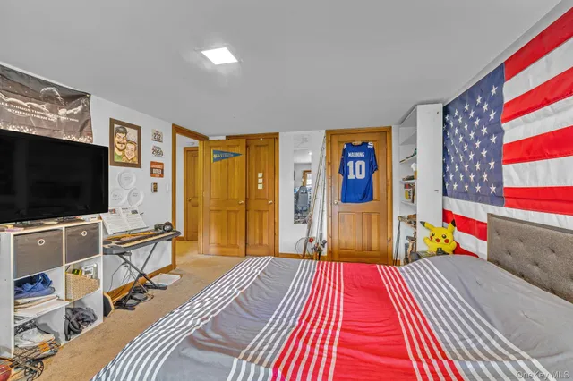 a bedroom with a bed and flat screen tv