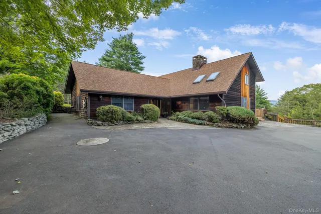a front view of a house with a yard and a garage