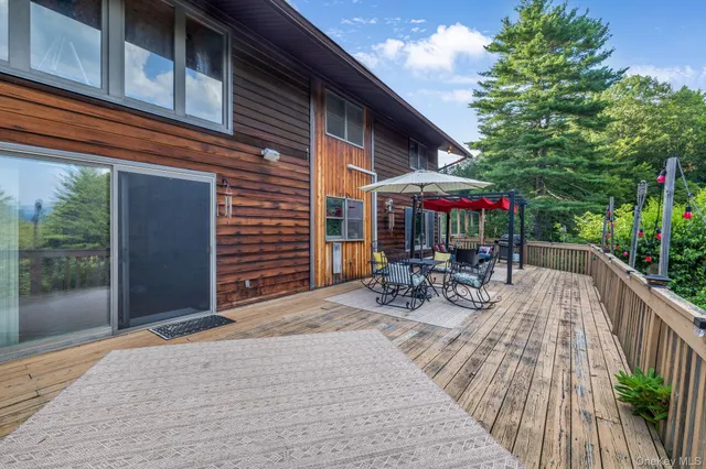 a view of backyard with a patio and deck