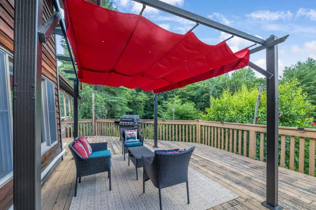 a view of a deck with a table and chairs under an umbrella