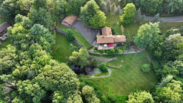 an aerial view of a house with a yard and fountain