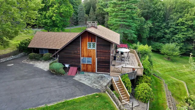 a view of a backyard with barn and a garden
