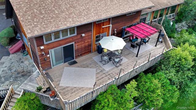 a front view of a house with a yard patio and outdoor seating