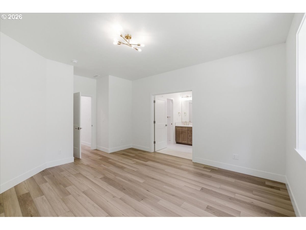 2147 Northeast Spitz Road Canby, OR 97013 - Photo 23 of 48 a view of an empty room with wooden floor