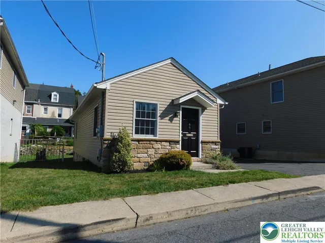 a front view of a house with a garden