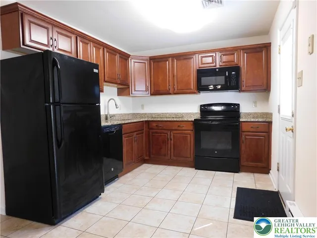 a kitchen with stainless steel appliances a refrigerator and a sink