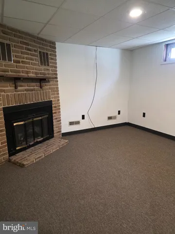 a view of an empty room with a fireplace