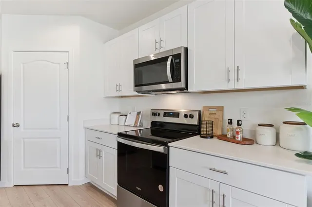 a kitchen with sink and view of living room