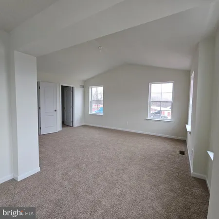 a view of an empty room with windows
