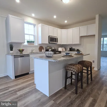 a kitchen with a sink a stove a microwave and cabinets