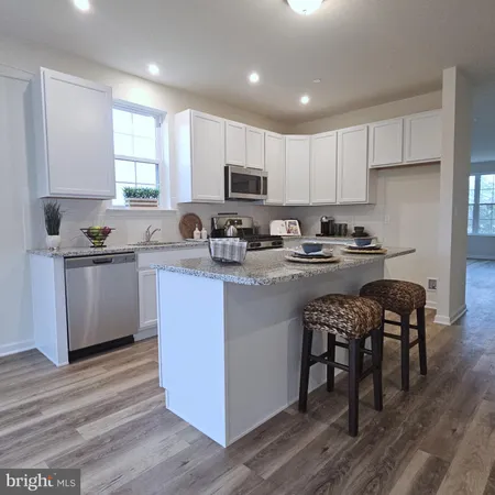a kitchen with a sink a stove a microwave and cabinets