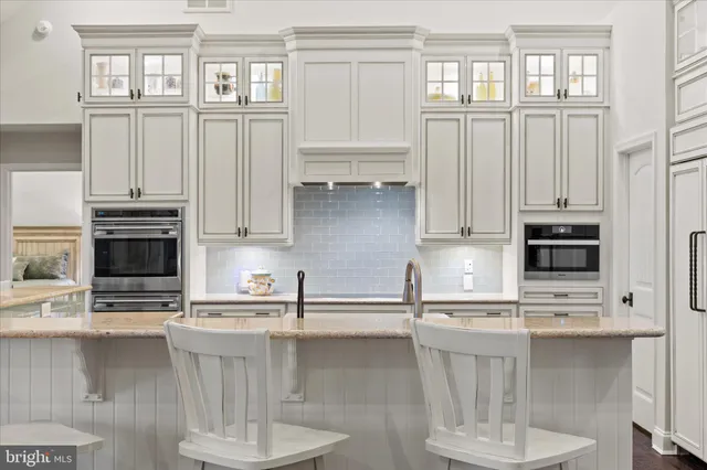 a view of a hallway with wooden floor and a bathroom