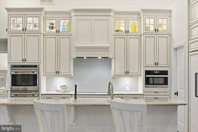 a bathroom with a granite countertop sink a toilet and a mirror