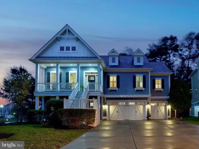 a large white kitchen with a sink stainless steel appliances and cabinets
