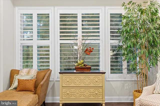 a living room with furniture a window and a flat screen tv