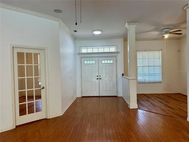 a view of a living room and kitchen floor with a ceiling fan