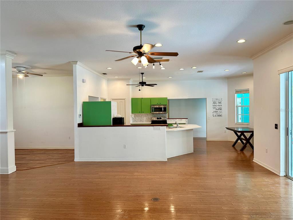5261 Waterwood Drive Bartow, FL 33830 - Photo 20 of 72 a view of living room with kitchen island stainless steel appliances furniture a fireplace and a chandelier