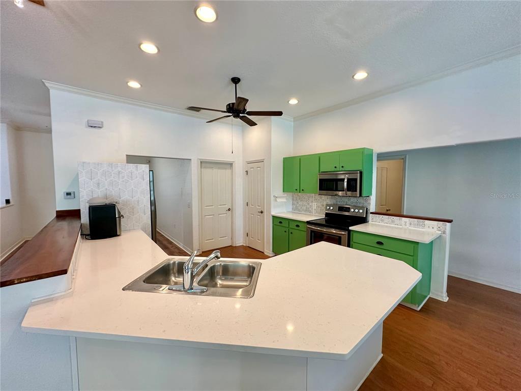 5261 Waterwood Drive Bartow, FL 33830 - Photo 26 of 72 a kitchen with a table chairs refrigerator and microwave