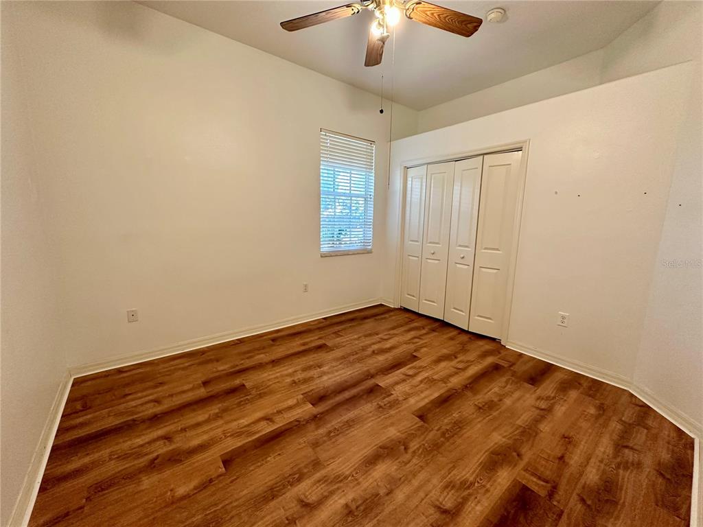 5261 Waterwood Drive Bartow, FL 33830 - Photo 32 of 72 an empty room with a chandelier fan and windows