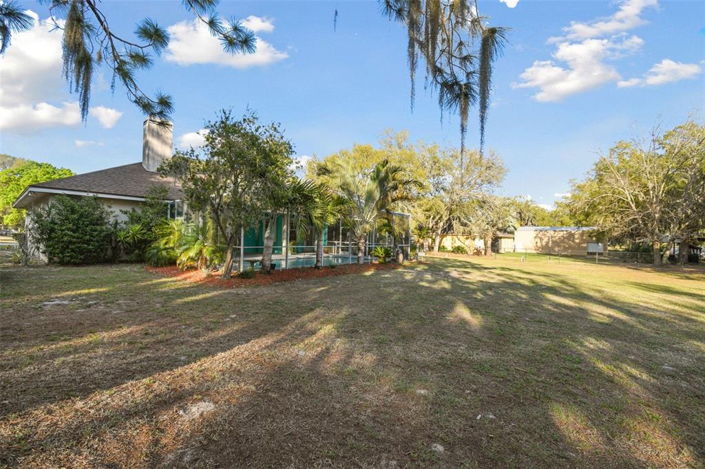 5261 Waterwood Drive Bartow, FL 33830 - Photo 49 of 72 a view of a street with flower plants and large trees