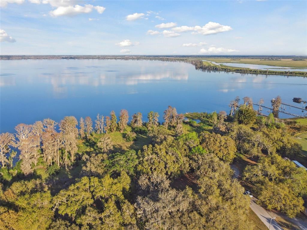 5261 Waterwood Drive Bartow, FL 33830 - Photo 66 of 72 a view of a lake with a building in the background