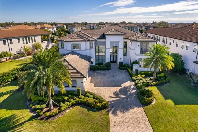 an aerial view of residential houses with outdoor space and swimming pool