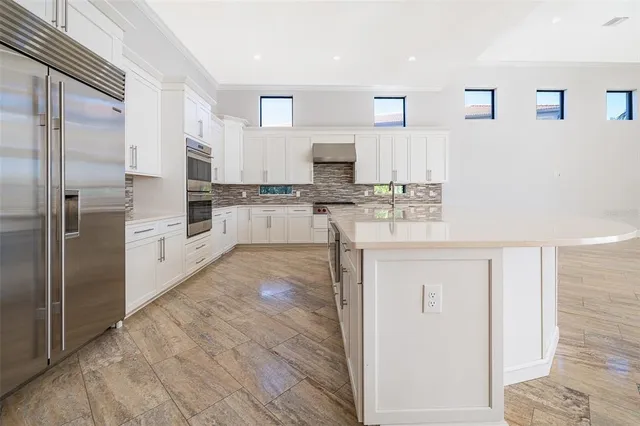 a large kitchen with stainless steel appliances lots of counter top space and cabinets