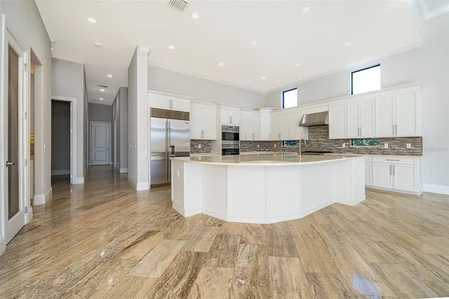 a kitchen with stainless steel appliances granite countertop a sink a stove and cabinets