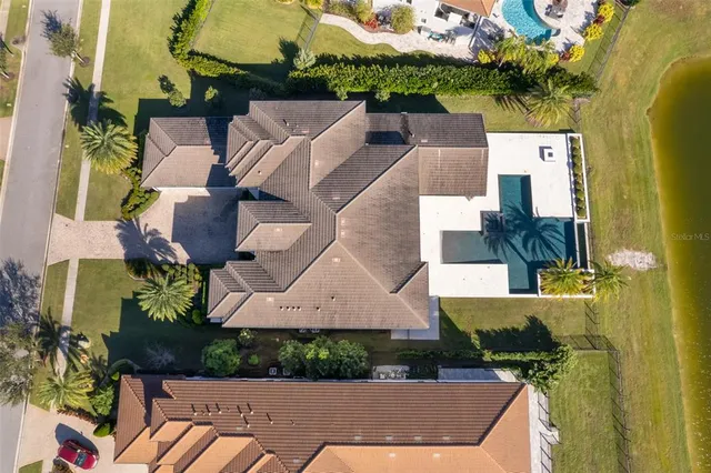 an aerial view of residential houses with outdoor space and swimming pool