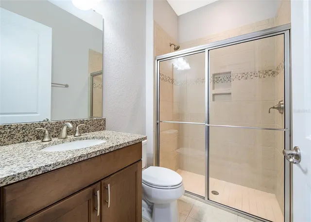 a view of wooden floor in an empty room with a window