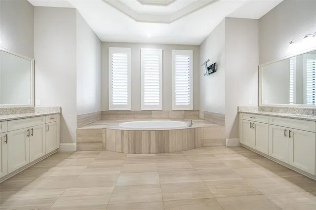 a bathroom with a granite countertop toilet sink and a mirror