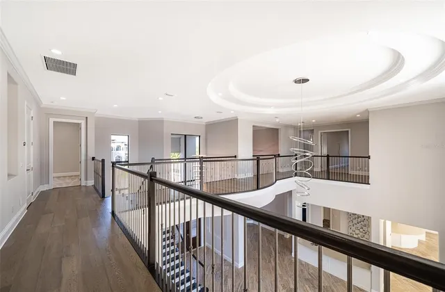 a view of a big room with windows and a bed