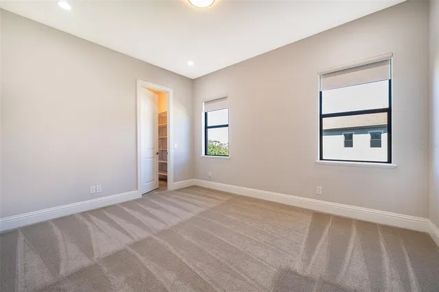 a view of house with swimming pool and outdoor seating