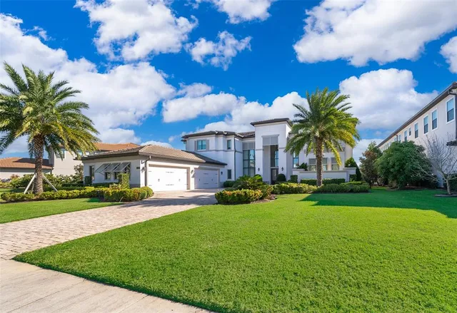 a view of a house with a yard and potted plants