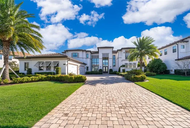 a front view of a house with a yard and a garage