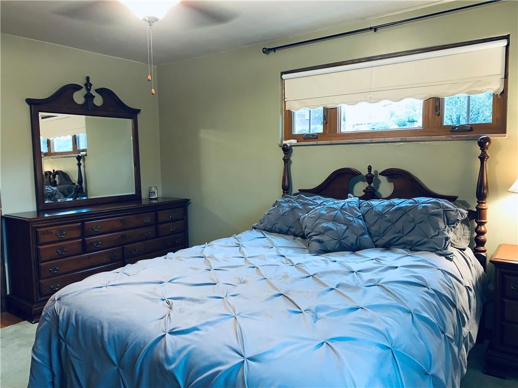4776 Rolling Hills Road Pittsburgh, PA 15236 - Photo 20 of 25 The 14x12 master bedroom has plenty of room for the largest of furniture.There are hardwood floors with an area rug.The higher windows better allow for large dressers without blocking daylight.