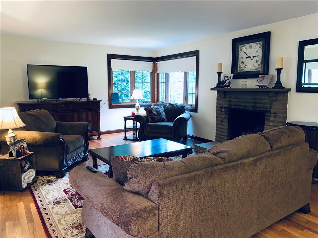4776 Rolling Hills Road Pittsburgh, PA 15236 - Photo 5 of 25 The spacious 22x13 living room has beautiful hardwood floors, a large corner window all owing tons of natural daylighting and a stone fireplace and mantel for seasonal cozy evenings.